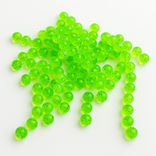 Neon green trout eggs on a white background