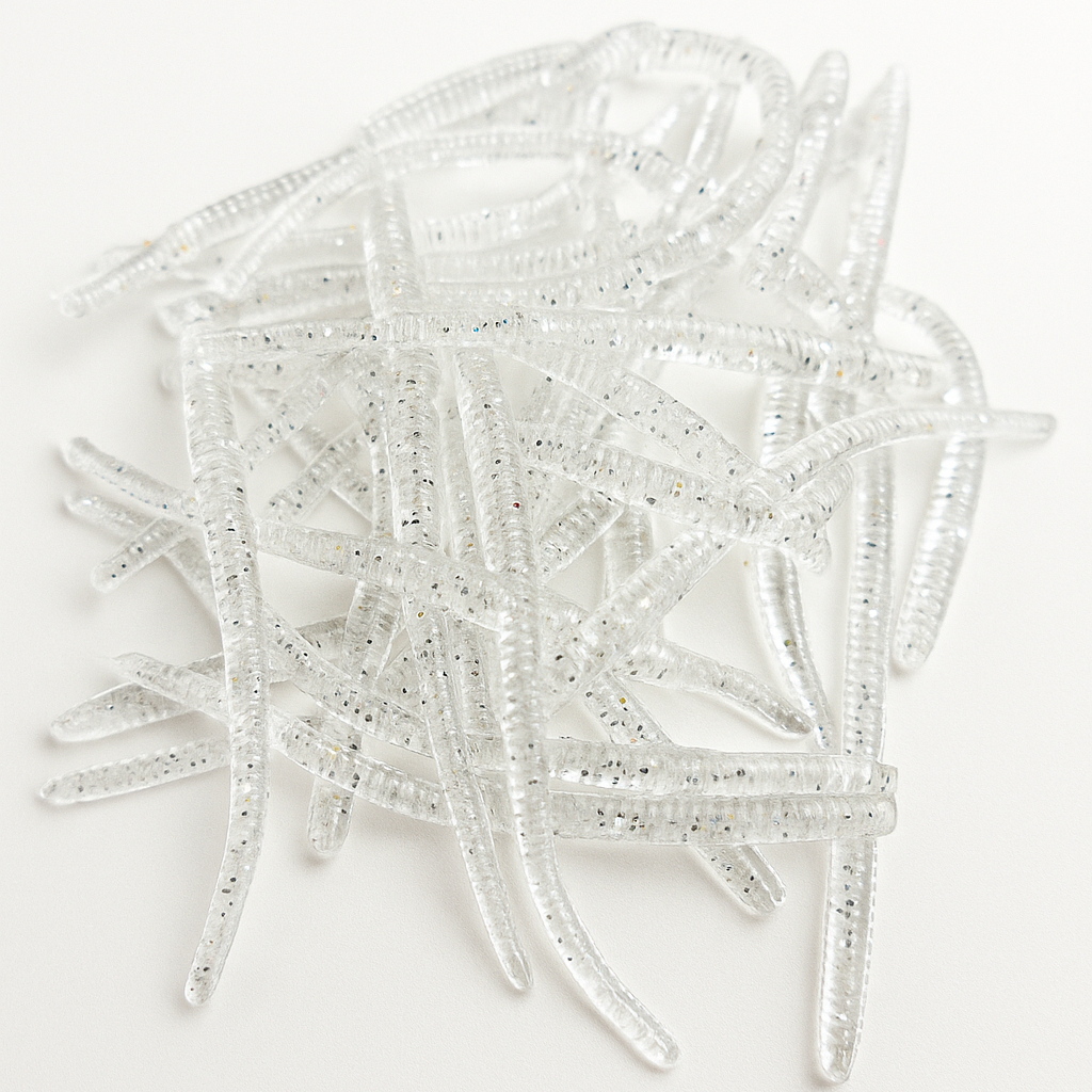 Clear plastic fishing lures on a white background